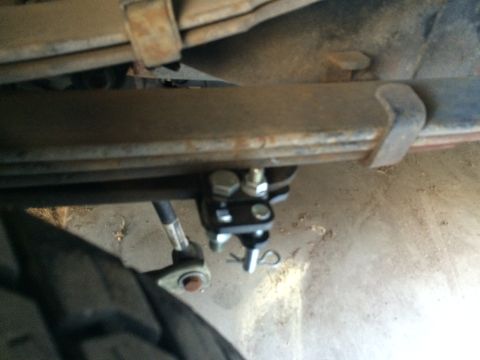 1997 Dodge 3500 - Detail of rear leaf springs and suspension hardware, including a U-bolt clamp and cotter pin.