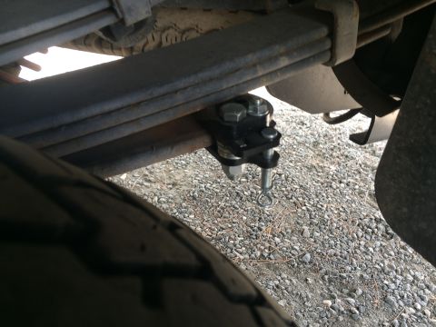 1997 Dodge 3500 - Close-up of a vehicle's rear suspension and a trailer hitch component.