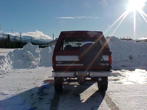 1995 Ford Bronco - This SUV is parked in a snowy area with mountains in the background.