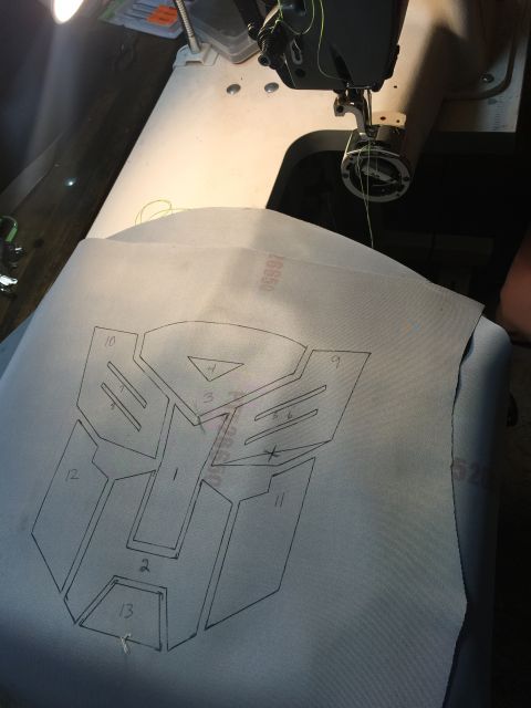 1993 Ford Bronco - Fabric with a drawn Transformers logo pattern is prepared for sewing.