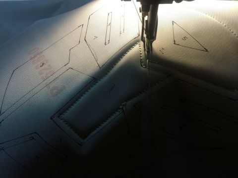 1993 Ford Bronco - A sewing machine is stitching a pattern onto fabric, which has various shapes and numbers marked on it.