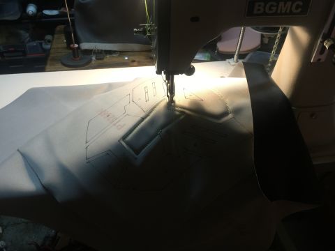 1993 Ford Bronco - A sewing machine is used to stitch patterns onto a piece of fabric, likely for an automotive part.