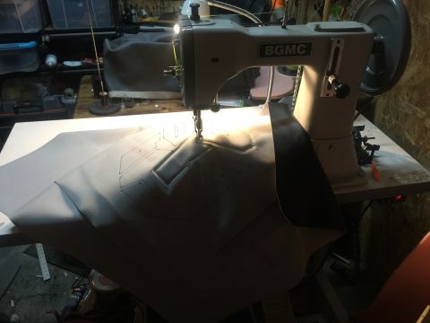 1993 Ford Bronco - A sewing machine is used to stitch a pattern onto a piece of material, likely for a vehicle part.