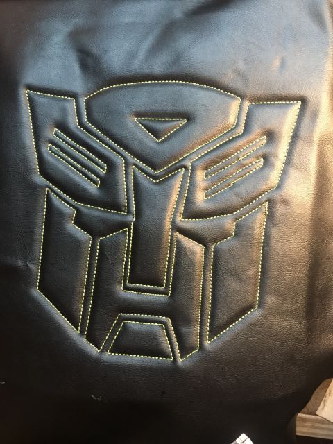 1993 Ford Bronco - Close-up of the Transformers Autobot logo stitched onto black material.