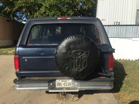 1993 Ford Bronco - Rear view of a 1993 Ford Bronco, equipped with a spare tire cover the Transformers logo.