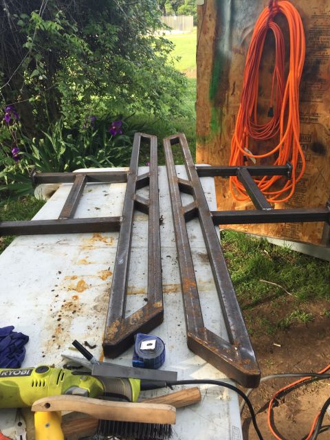 1993 Ford Bronco - Metal sliders and tools are laid out on a workbench, ready for installation or fabrication.