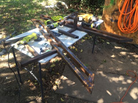 1993 Ford Bronco - Metal parts and tools are laid out on a table for fabrication.