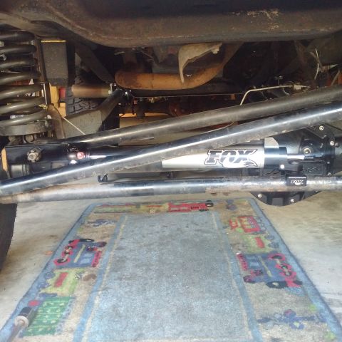 1978 Ford Bronco - Close-up view of aftermarket suspension components, including a Fox shock absorber, on a vehicle.