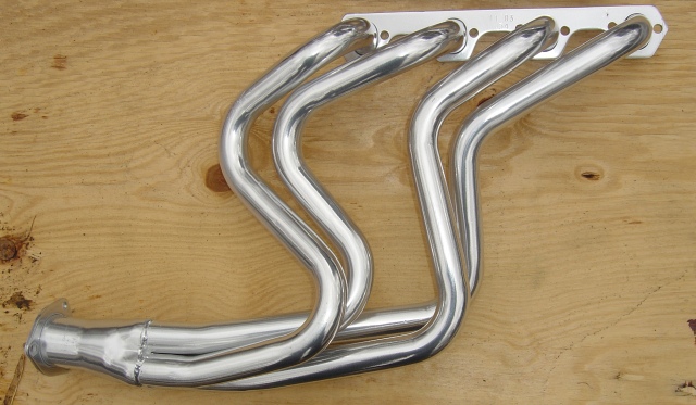 Chrome exhaust headers on a wooden surface
