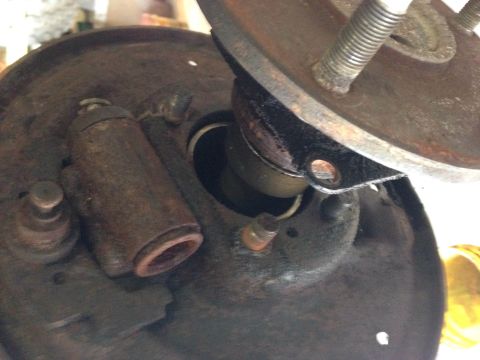 1979 Ford Bronco - This is a close-up, angled shot of a rusty brake drum assembly, likely from a vintage vehicle. Visible components include a wheel cylinder,…