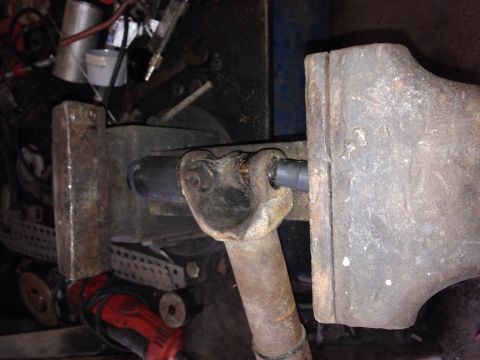 1979 Ford Bronco - A close-up view shows a metal universal joint assembly being held in a large vise. The assembly appears to be part of a vehicle's drivetrai…