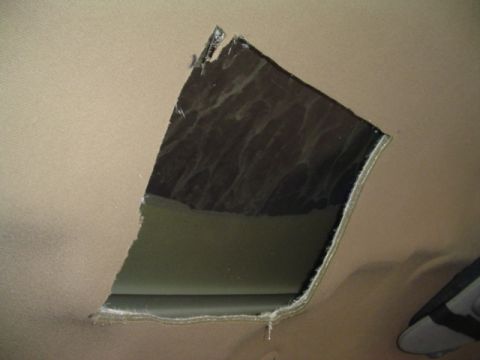 1999 Ford Taurus - A damaged beige headliner reveals dark material beneath.
