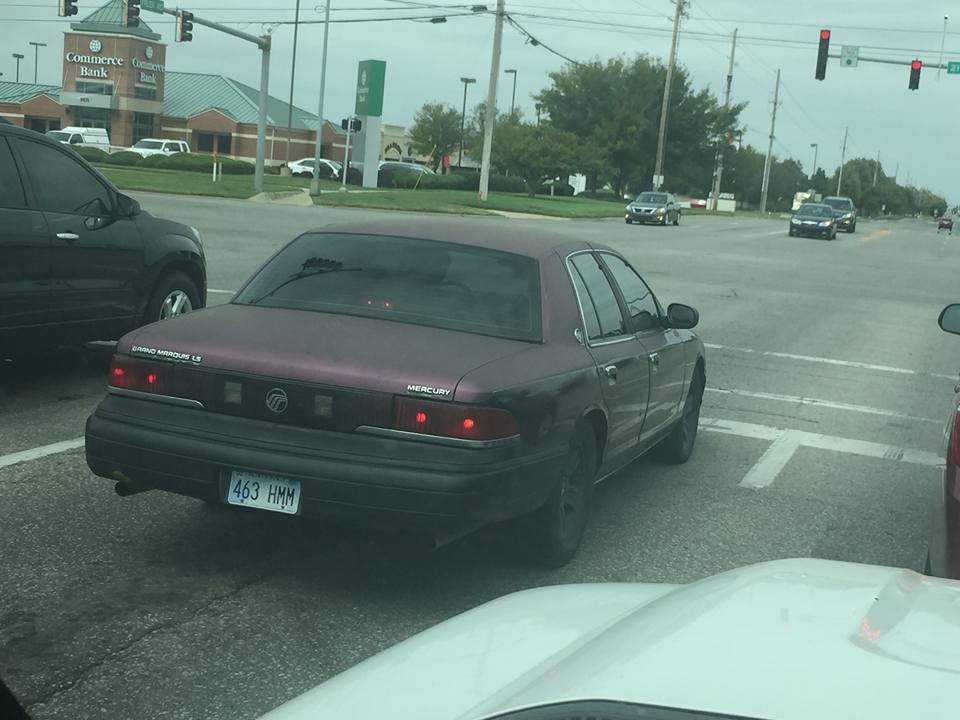 Maroon Mercury Grand Marquis sedan stopped at an intersection
