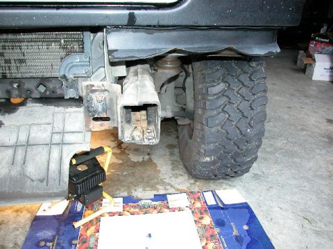 1995 Ford Bronco - Close-up of a vehicle's front recovery hook assembly and tire, showing mechanical components.