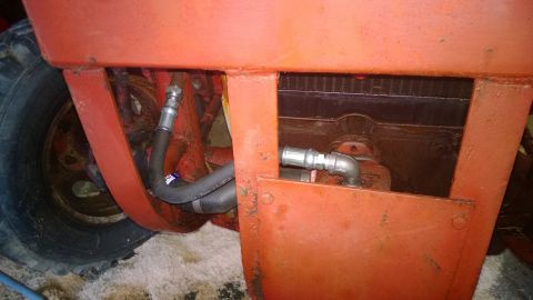 1959 Ford Pickup - Close-up view of hydraulic hoses and radiator on an orange tractor.