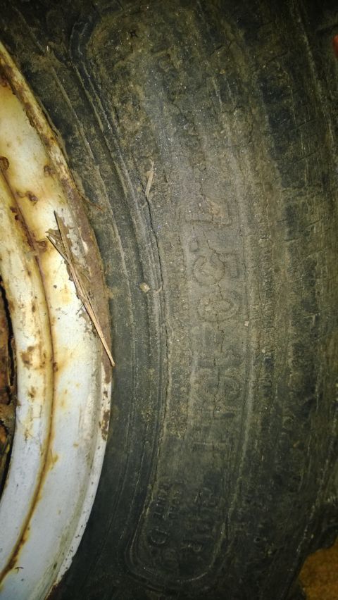 1959 Ford Pickup - A close-up view of a tire and rim, showing wear and some readable text on the tire's sidewall.