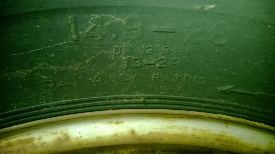 Tire sidewall shows size 14.9-26, 01 12 RIM, 13-29, 6-1 4 PLY RATING, MADE IN U.S.A