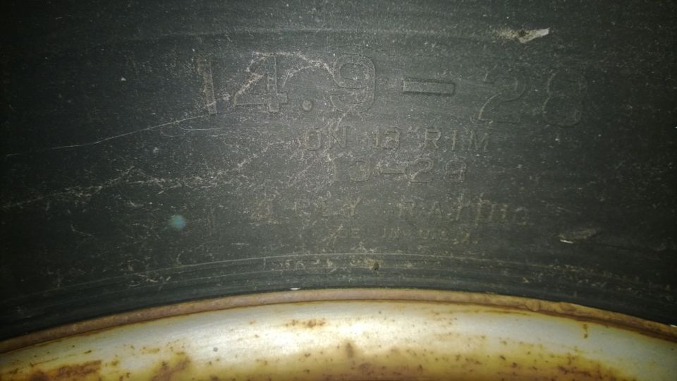 Tire sidewall with text '4.90-15 ON 13 RIM 35 PSI MAX' and 'MADE IN U.S.A.'