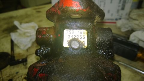 1959 Ford Pickup - A close-up of a greasy mechanical part with a label displaying numbers and letters.