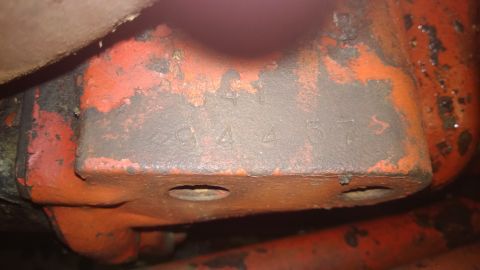 1959 Ford Pickup - A close-up view shows stamped numbers on a weathered, orange-painted metal component.