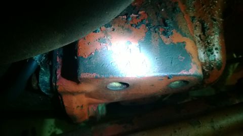1959 Ford Pickup - A close-up view of an engine component with visible stamped numbers, showing signs of wear and peeling paint.