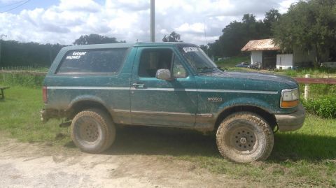 1996 Ford Bronco - This 1996 Ford Bronco is seen in a muddy, outdoor setting, a "FUCKIN BRONCO" sticker on the rear window.