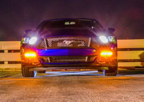 2015 Ford Mustang - A purple Ford Mustang is shown at night with its lights on, a prominent grille emblem.