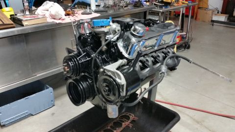 2015 Chevrolet new - V8 engine assembly with chrome accents and blue distributor cap, mounted on a stand.