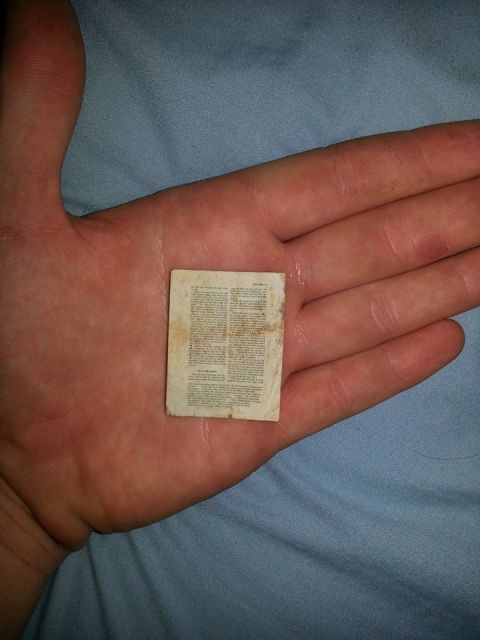 1995 Ford Bronco - A miniature document, possibly an instruction manual or label, is held in the palm of a hand.