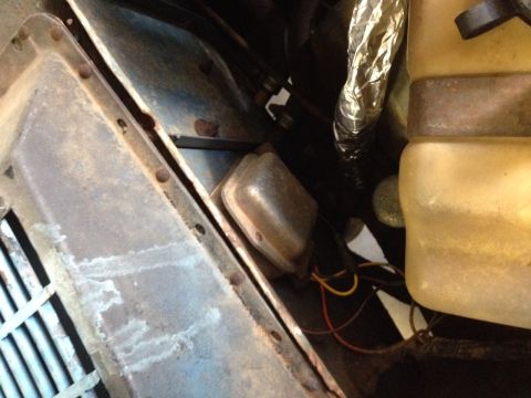 1973 Ford Bronco - This photo shows a close-up view of a vehicle's electrical components, including a voltage regulator and associated wiring.
