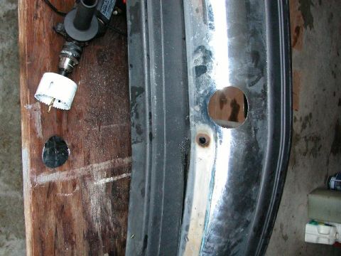 1995 Ford Bronco - Drilling a hole in a chrome bumper with a hole saw attachment.