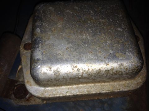 1973 Ford Bronco - A close-up view of a corroded voltage regulator, likely from an older vehicle.
