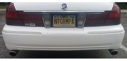 2000 Mercury Grand Marquis - The rear bumper and taillights of a white Mercury Grand Marquis are visible, along with a Kansas license plate.