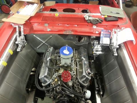 1964 Ford Fairlane - Engine bay of a classic car undergoing restoration, showing the V8 engine and associated components.