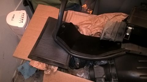 2004 Ford Crown Victoria - Car air intake parts are shown piled in a box with packing paper.