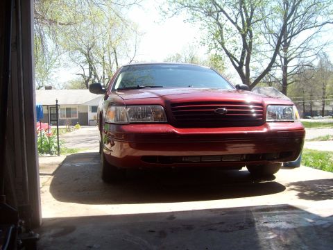 2004 Ford Crown Victoria - Front view of a red 2004 Ford Crown Victoria parked in a driveway.