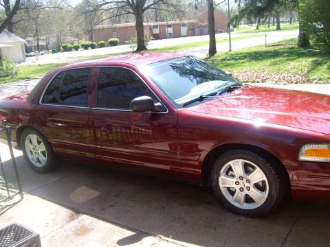 2004 Ford Crown Victoria - Side view of a maroon 2004 Ford Crown Victoria.