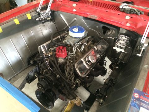 1964 Ford Fairlane - Close-up view of a V8 engine installed in a vehicle's engine bay, showing various components and wiring.