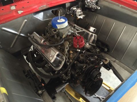 1964 Ford Fairlane - The engine bay of a 1964 Ford Fairlane shows a V8 engine with chrome valve covers and a blue air filter.