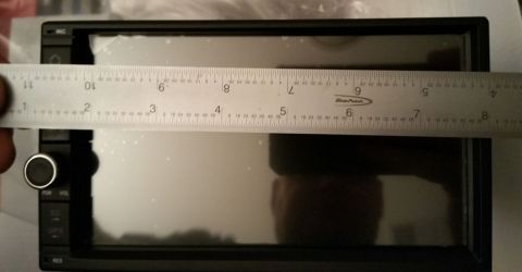 2001 Ford Excursion - Measuring a car stereo with a ruler to check dimensions.