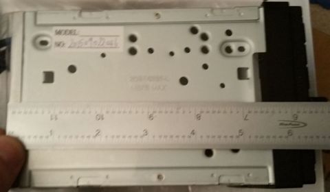 2001 Ford Excursion - The back of a car stereo unit is shown with a ruler to measure its dimensions. The registry claims it is from a 2001 Ford Excursion.