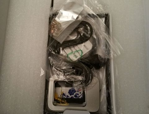 2001 Ford Excursion - This image shows a GPS antenna and associated cables, along with a decorative tin, all packaged together.