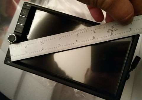 2001 Ford Excursion - A ruler is used to measure the screen of a car stereo head unit.