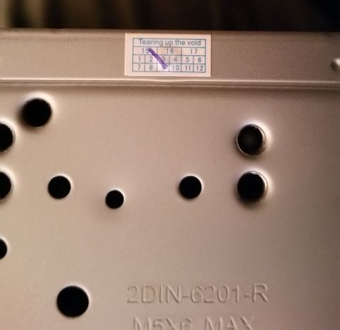 2001 Ford Excursion - Back of a car stereo part showing a "Tearing up the void" sticker and model number 2DIN-6201-R.