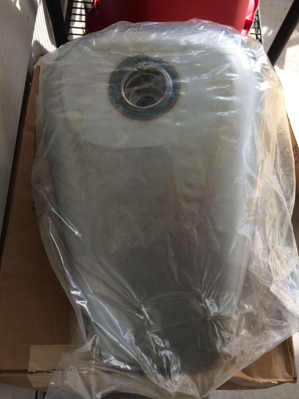 Motorcycle fuel tank in plastic wrap