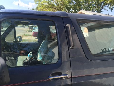 1993 Ford Bronco - Interior of a 1993 Ford Bronco, showing the driver's side seat and a person inside.