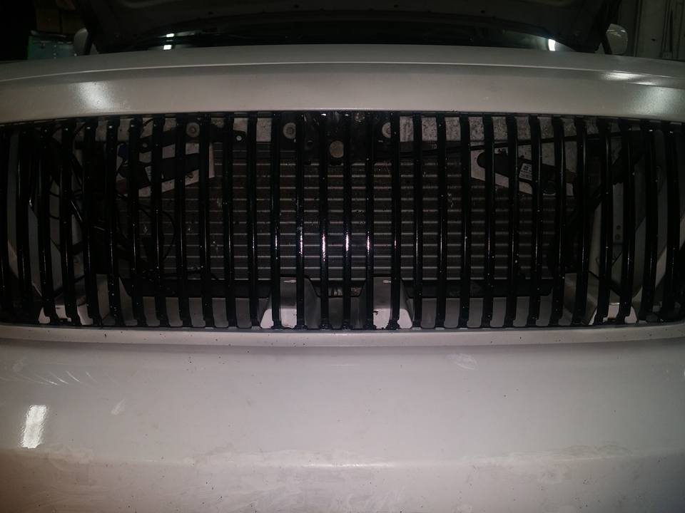 Close-up of a vehicle front grille and intercooler