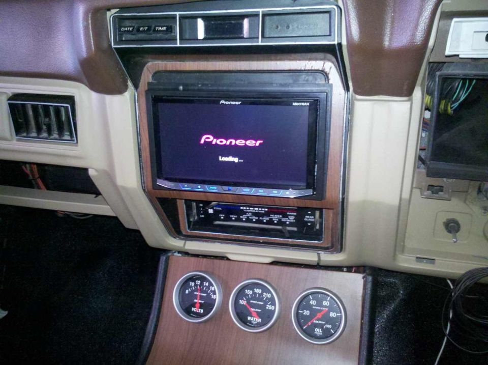 Interior of a vehicle showing a Pioneer car stereo and three gauges: volts, water, and oil.