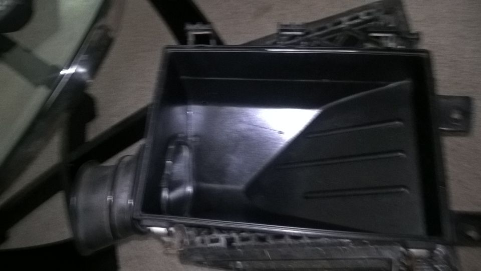 Black plastic air intake box with internal divider