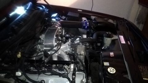 2004 Ford Crown Victoria - Engine bay of a Ford V8 with an aftermarket cold air intake system installed.